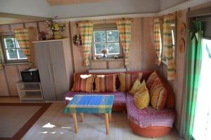 a living room with a couch and a table at Holzhaus in Hauzenberg