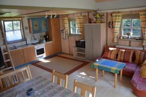 a kitchen and living room with a couch and a table at Holzhaus in Hauzenberg