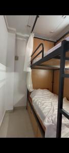 a small room with two bunk beds in it at RDA Dormitory in Raipur