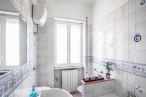 ein Bad mit einem Waschbecken, einem WC und einem Fenster in der Unterkunft A Casa Scipione in Formia