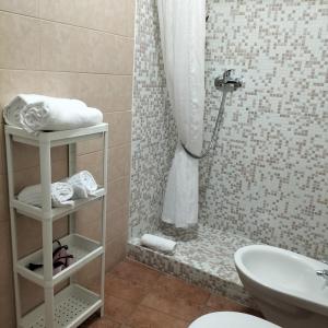a bathroom with a shower with a toilet and a sink at Bed And Breakfast Nelmuro in Matera