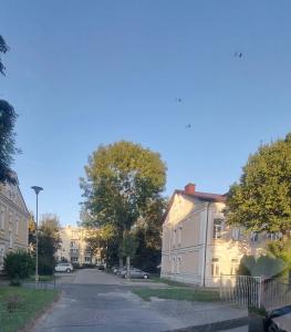 an empty street in a residential neighborhood with buildings at APARTAMENT KRESOWY całe mieszkanie aneks kuchenny wi fi parking in Hrubieszów