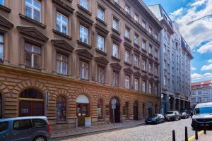 a building on a street with cars parked in front of it at New modern apartment 5. floor in Prague