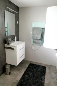 a bathroom with a white sink and a mirror at Villa Sorgenfrei in Reutte