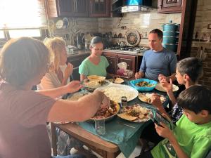 a group of people sitting around a table eating food at Beida Bedouin House in Al Ḩayy