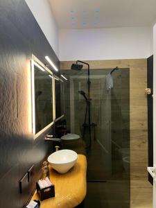 a bathroom with a sink and a shower at Suite ZEUS in La Spezia