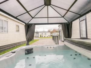 a hot tub in the backyard of a house at Yealand 36 in Carnforth