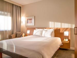 a hotel room with a large bed and a window at Novotel Gaziantep in Gaziantep