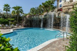 a swimming pool with a waterfall at Hyatt Regency Orlando in Orlando