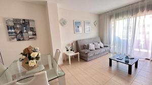 a living room with a couch and a table at APARTAMENTO LOS GIRASOLES 1 in Salou