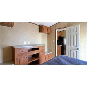 a kitchen with wooden cabinets and a counter top at JW Coffeyville in Liberty