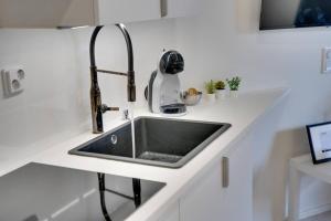 a kitchen counter with a sink and a mixer at Upea yksiö+parveke. Ihastu, parhaalla paikalla. in Tampere +1 photo