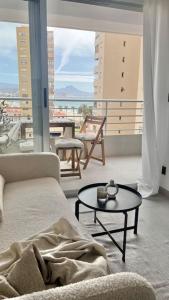 a living room with a couch and a table at Nuevo apartamento 1 linea! in El Campello