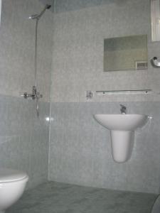 a bathroom with a sink and a toilet at Hotel Sunrise in Ravda +30 photos