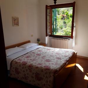 1 dormitorio con cama y ventana en Le Ginestre, en Levanto