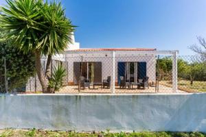 una casa bianca con una palma e una piscina di Monte dos Sabores a Lagos