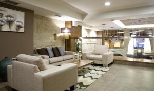 a living room with two couches and a table at Hotel Arsus in Vigo