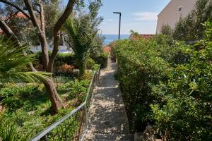 a path through a garden next to a fence at Blue Horizon in Dubrovnik