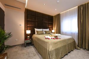 a bedroom with a large bed with flowers on it at Luxury Rooms LaVie - Standard Rooms in Zadar