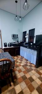 a kitchen with a checkered floor and a table in a room at Casa Cica in Ubatuba