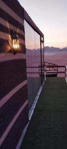 a building with a light on the side of it at Wadi Rum Majestic Camp in Wadi Rum