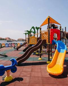 um parque infantil com escorrega em Apartment in Sea Breeze - Park Residence em Baku