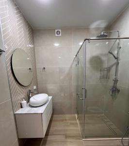a bathroom with a shower and a toilet and a sink at Apartment in Sea Breeze - Park Residence in Baku