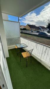 un patio con 2 sillas y una mesa en el balcón en Nant'Sud Loire, en Nantes