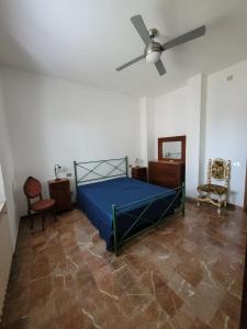 - une chambre avec un lit et un ventilateur de plafond dans l'établissement La Lenzerina Casa indipendente con giardino, à Scarlino