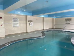 a pool in a building with a swimming pool at Wingate by Wyndham Savannah Gateway in Savannah