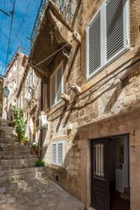 an old stone building with a door and stairs at House Old Town Dubrovnik in Dubrovnik