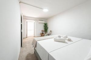 a white bedroom with a large white bed at House Old Town Dubrovnik in Dubrovnik