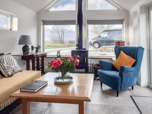 a living room with a couch and a table at Cuillin View in Torrin