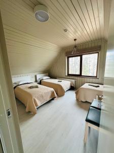 a bedroom with two beds and a window in it at Green Town in Vievis