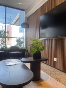 a living room with a table and a potted plant at Umhlanga Arch Sea View Apartment in Durban