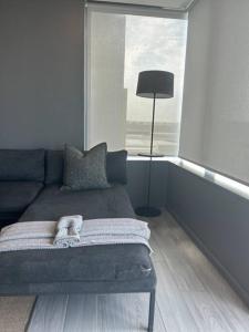 a living room with a couch and a window at Umhlanga Arch Sea View Apartment in Durban