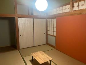 a room with white lockers and a table in it at みやうら御殿 in Imabari