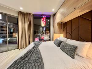 a bedroom with a large white bed with pillows at ZEN Suites Hotel Massira in Casablanca +82 photos