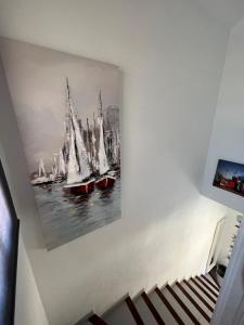 a painting hanging on a wall with boats at Casa Ucraniana Wi-Fi fibra in Costa Calma +40 photos