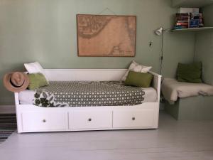 a childs bedroom with a white bed in a room at Havings skafferi in Lysekil
