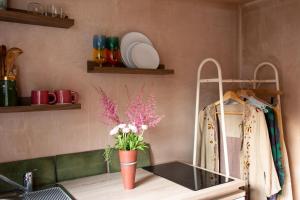 a kitchen counter with a vase of flowers on it at Garden Studio Annex w/free parking in Hemel Hempstead