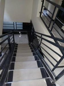a staircase in a building with black and white tiles at Comfy Haven -Rustic studio apartment in Donholm in Nairobi