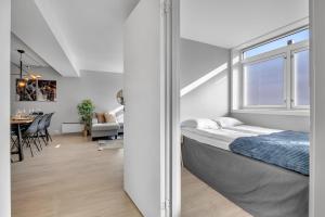 a bedroom with a bed and a dining room at Arctic Homes - The Aurora Retreat in Tromsø