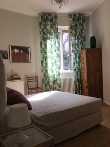 a bedroom with a bed and a dresser and a window at Solare residenza vista mare in Rapallo +55 photos