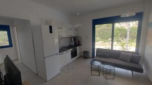 a living room with a couch and a kitchen at Villa Edna Crete in Agios Nikolaos