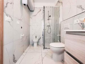 a white bathroom with a toilet and a shower at Studio in San Michele al Tagliamento 42856 in San Michele al Tagliamento +21 photos