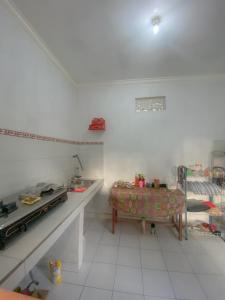 a white room with a table and a chair at Kubu Indah Guest House in Nusa Penida +17 photos