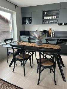 a kitchen with a table and some chairs and a stove at Fjällglim36 in Sälen