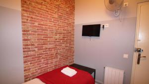 Televízia a/alebo spoločenská miestnosť v ubytovaní Paraiso Hostel