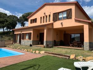 a house with a swimming pool in front of it at CAL XECARMA in Tordera